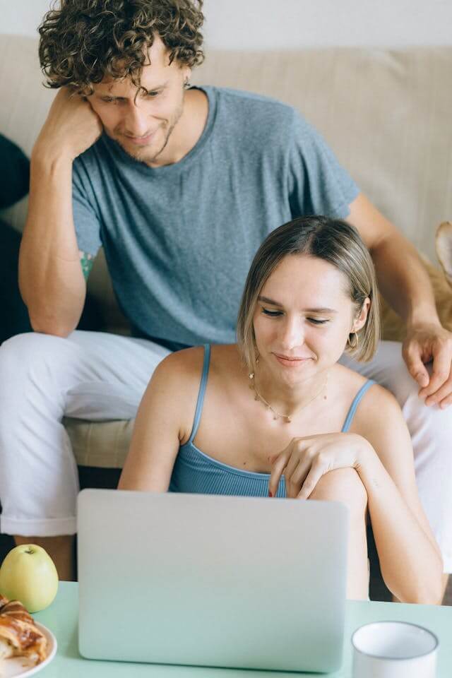 Couple reviewing their finances together while applying for a debt consolidation loan online