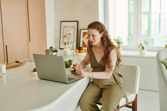 Woman reviewing her payslips on a laptop at home.