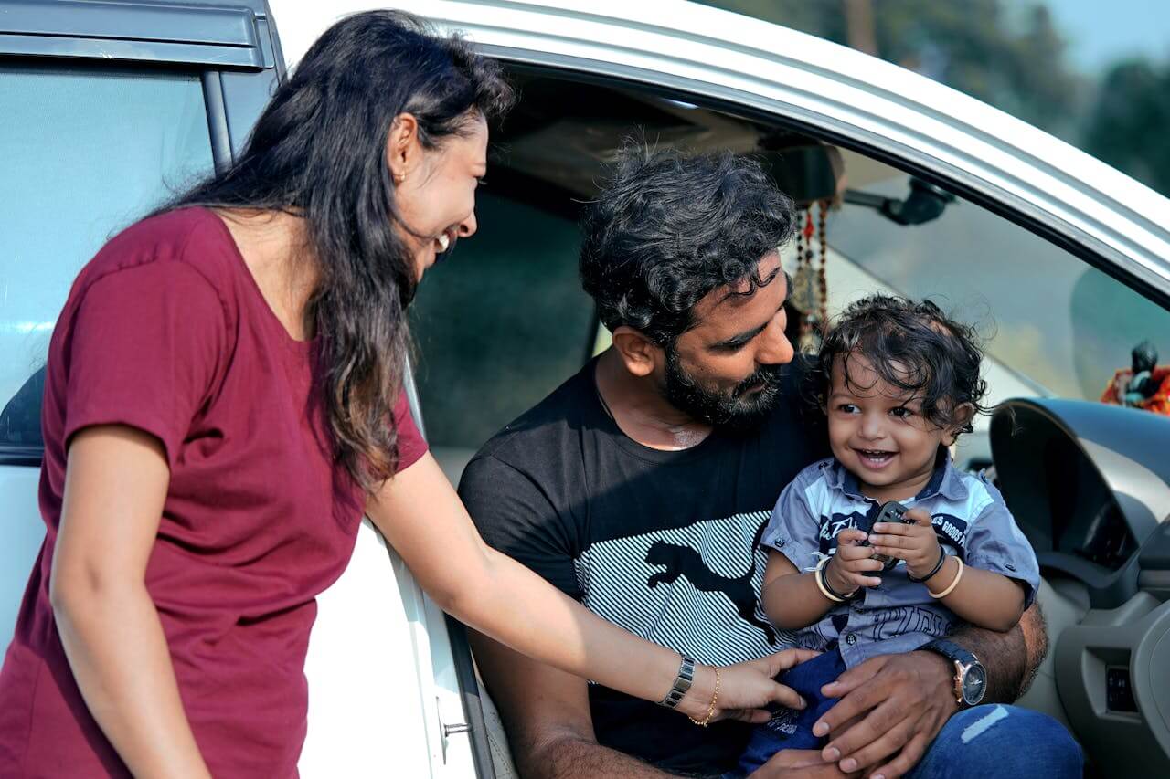 Family sitting in a car while considering vehicle finance options