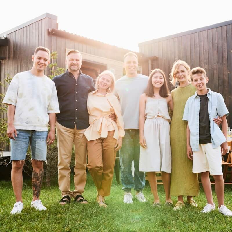 A family celebrates their new joint home purchase together outside
